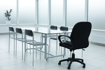 Black chairs glass table in office space