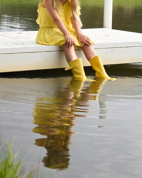 Child Looking at Reflection in Water