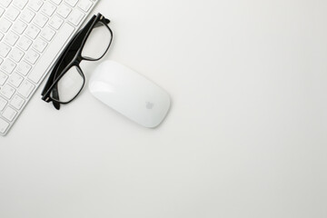 Office workplace with keyboard mouse and glasses