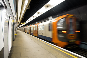 Lighted subway station with blurred train