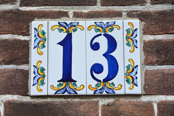 Fototapeta premium Number 13 on the house wall