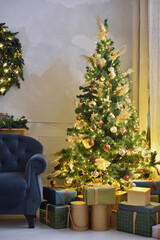 Christmas tree with yellow garlands and gifts