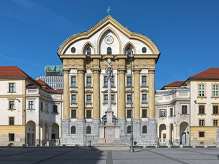 Fototapeta na wymiar Ursuline Church of the Holy Trinity and Holy Trinity Column on Congress Square of Ljubljana, Slovenia. The church was built in 1718-1726. The Column was created in 1722 and renovated in 1834 and 1895.