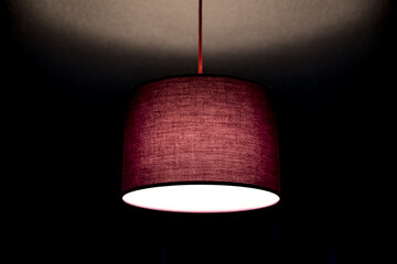 purple ceiling lamp lit in dark room