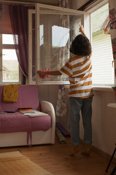 Cute girl cleaning window