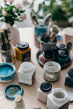 Jars of paint on table