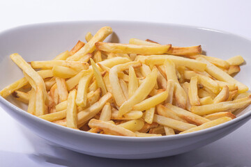 French fries make in oven on a white  plate
