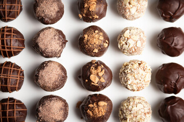 variety of handmade gourmet chocolate truffle candy on a white plate