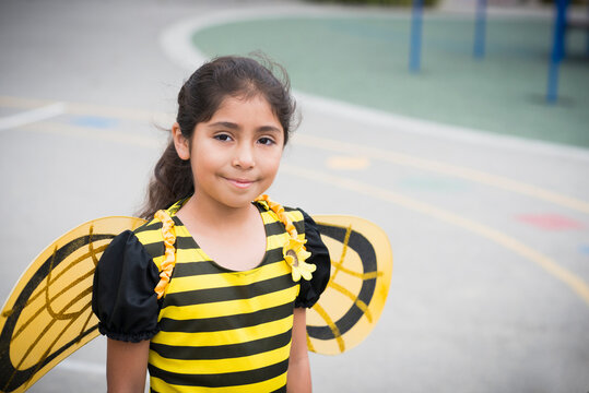 Portrait of Hispanic girl in bee costume