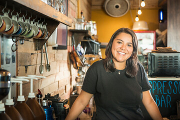 Hispanic woman working in coffee shop