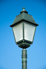Fototapeta na wymiar Old street lamp on blue sky background