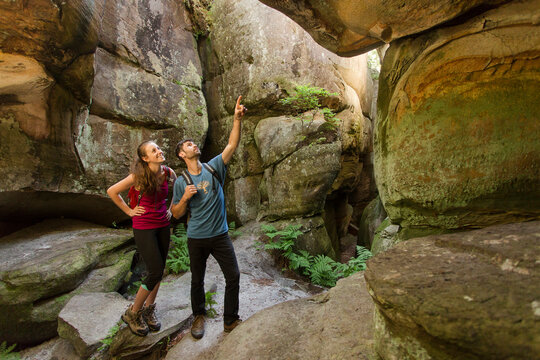 Caucasian couple exploring cave