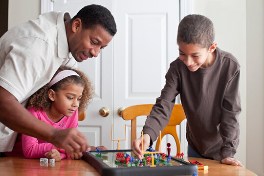 Family playing board game together