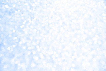 Abstract blue and white bright shiny light bokeh background.  Snowfall, snowflake, winter season, New Year, Christmas and all celebrations background concept. 