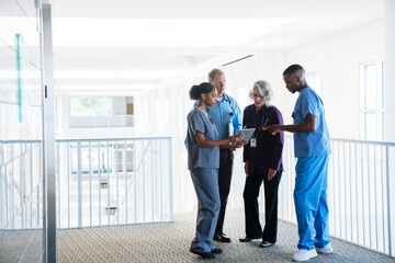 Doctors and nurses discussing digital tablet