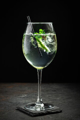 Hugo cocktail with champagne, lime, mint and Melissa syrup on a black background, aperitif drink - obrazy, fototapety, plakaty