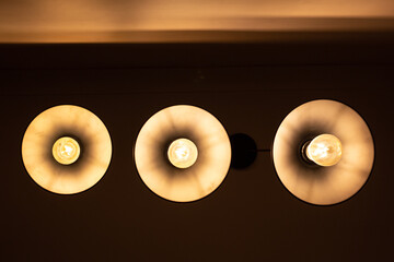 Three round lamps on the ceiling, bottom view