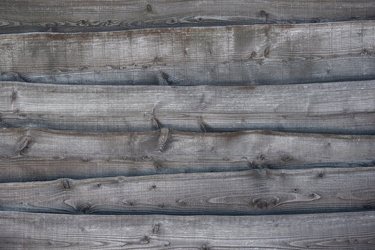 Full frame image of a rustic grey wooden background with horizontal lines with space for copy