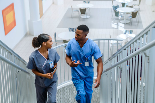 Nurses climbing staircase and talking