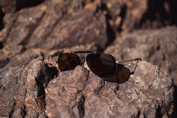 sun glasses on rock