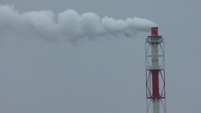 Water vapor from the plant pipes. Damage to the environment and climate due to the greenhouse effect of human production.