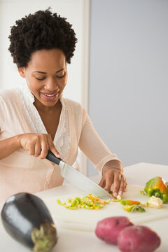 Black Woman Slicing Vegetables