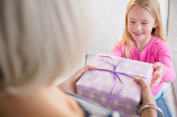 Senior Caucasian woman giving granddaughter present