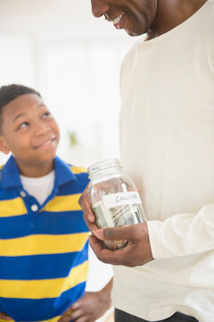 Father and son saving money for college