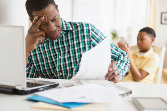 Anxious father paying bills online