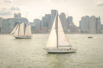 Sailboats cruise around Boston Harbor