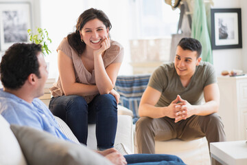 Hispanic friends talking in living room