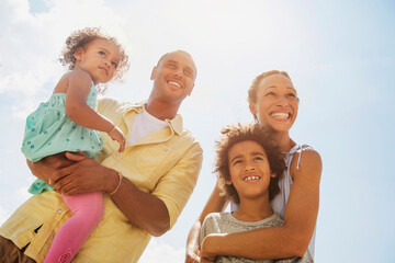 Low angle view of family smiling together outdoors