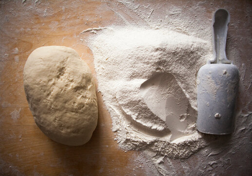 High angle view of flour and dough on table