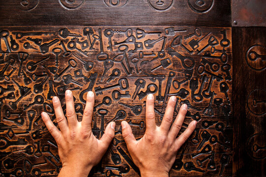 Close up of hands of Mari man hands on wooden surface