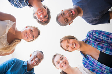 Low angle view of teenagers standing in circle