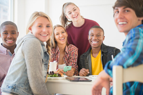 Teenagers smiling at table