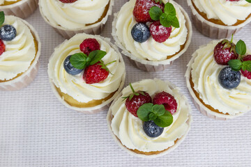 Delicious muffins with fresh strawberries, raspberries, blueberries. Light dessert.