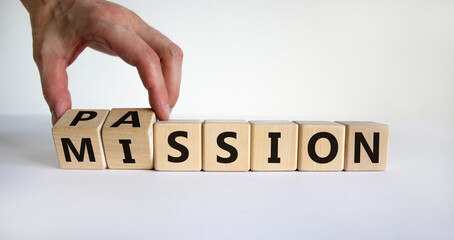 Do your mission with passion. Male hand flips wooden cubes and changes the word 'mission' to...