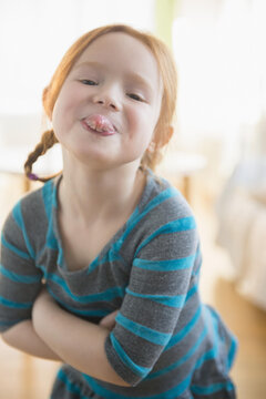 Defiant Caucasian girl sticking out tongue