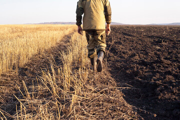 Mari farmer walking in crop fields