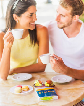 Hispanic couple having coffee at cafe