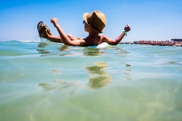 Mari boy floating in inflatable ring in ocean