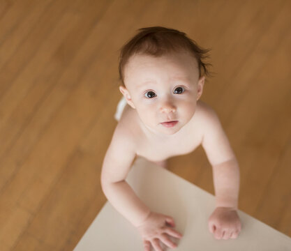 Caucasian baby looking up at table