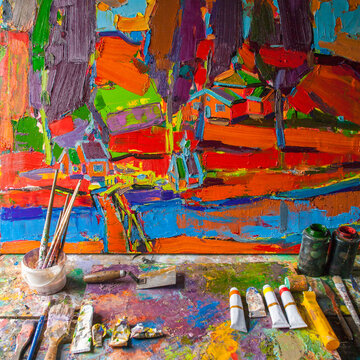 Painting on easel with paint and paintbrushes