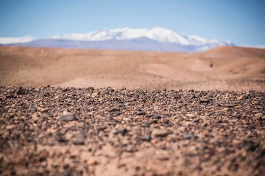 Surface level view of gravel field and remote desert