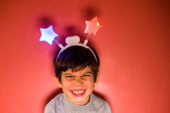Mixed race boy wearing headband with stars