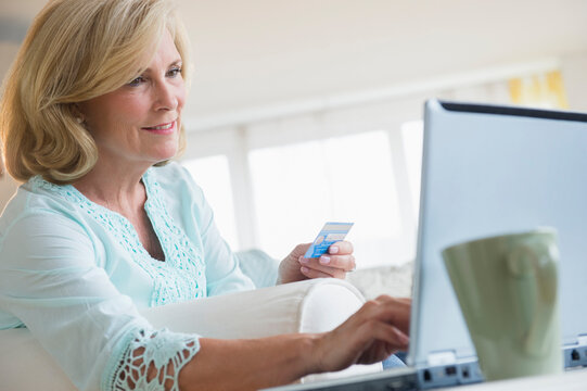 Caucasian woman shopping online with laptop