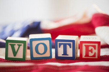 Close up of vote toy blocks on American flag