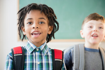 Students wearing backpacks in classroom