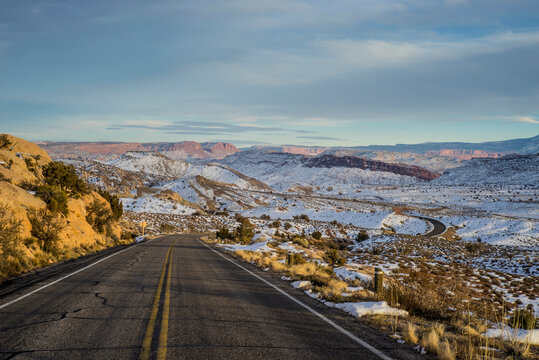 Empty road through snowy remote landscape, Moab, Utah, United States